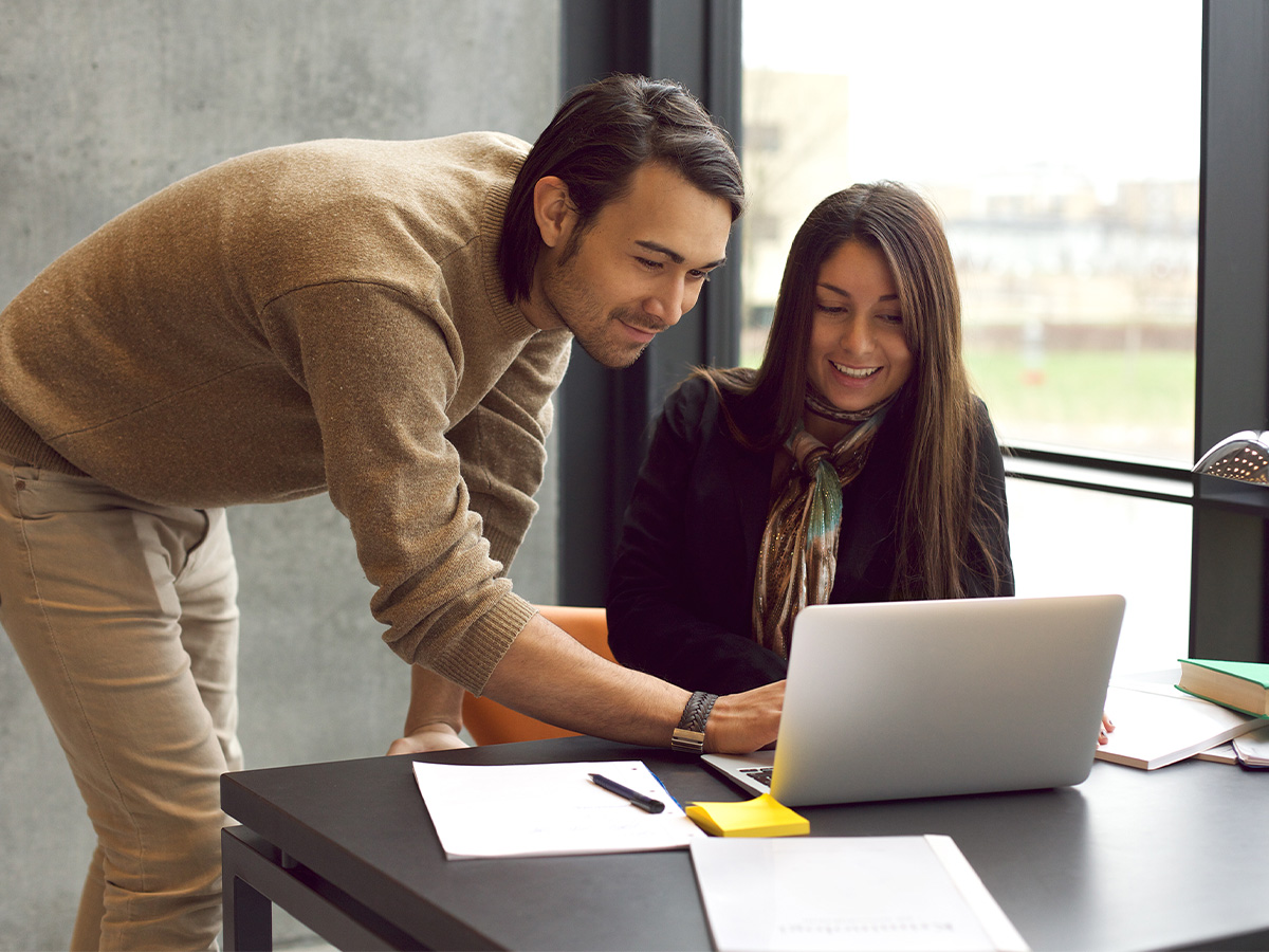 young couple looking at a computer screen
