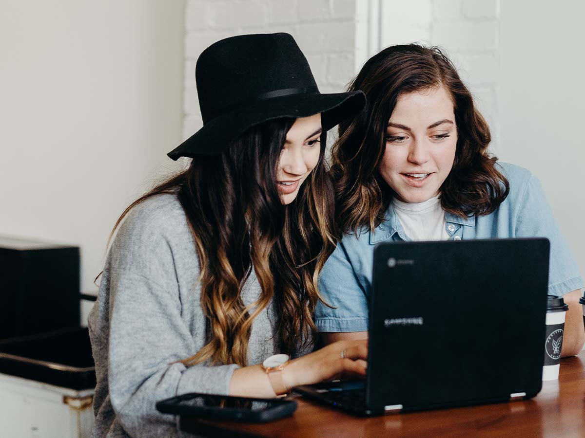 Two young women looking at a laptop
