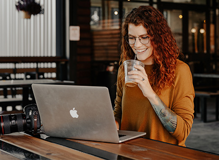 Woman smiling while using a laptop