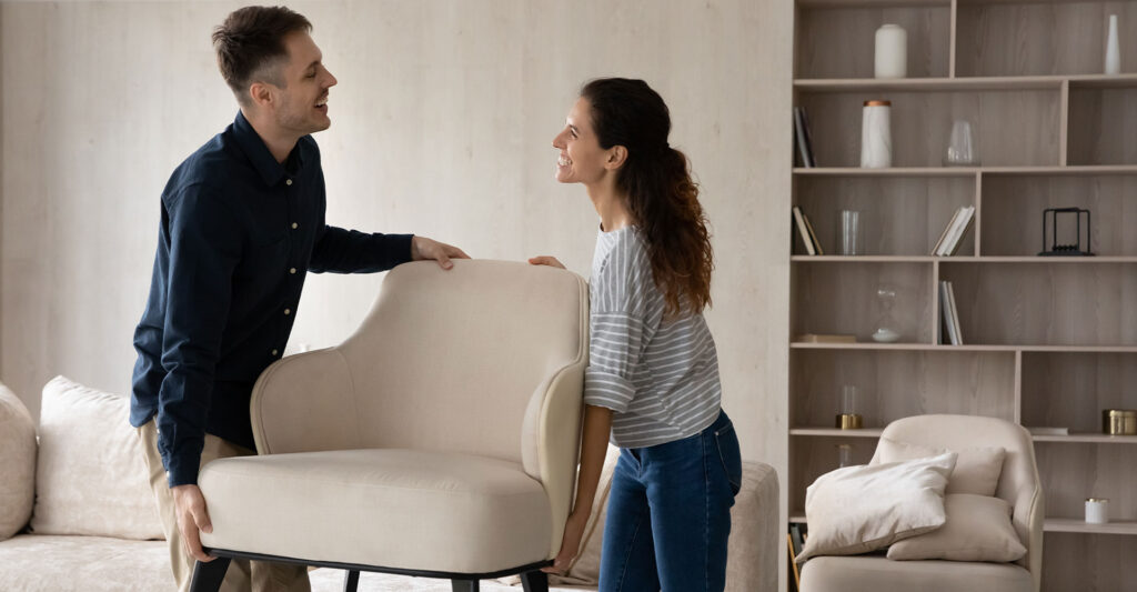 people moving furniture in a house