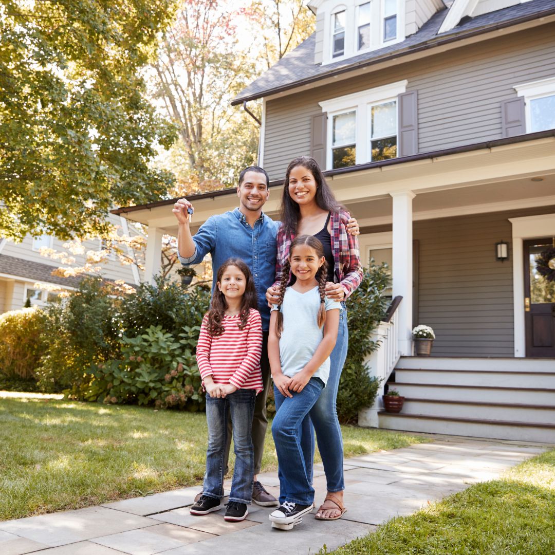 family in front of house