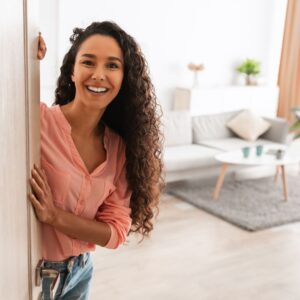 a woman opening the door of her apartment