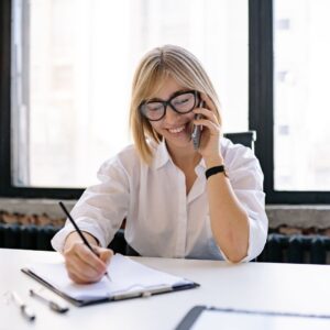 a woman on the phone taking notes