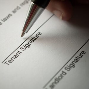 a person signing a rental agreement