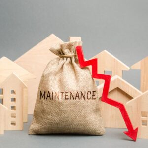 Burlap bag with the word "Maintenance" on it and a red arrow pointing down surrounded by wooden model houses.