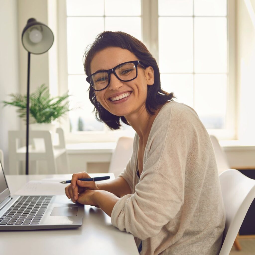 woman smiling at desk